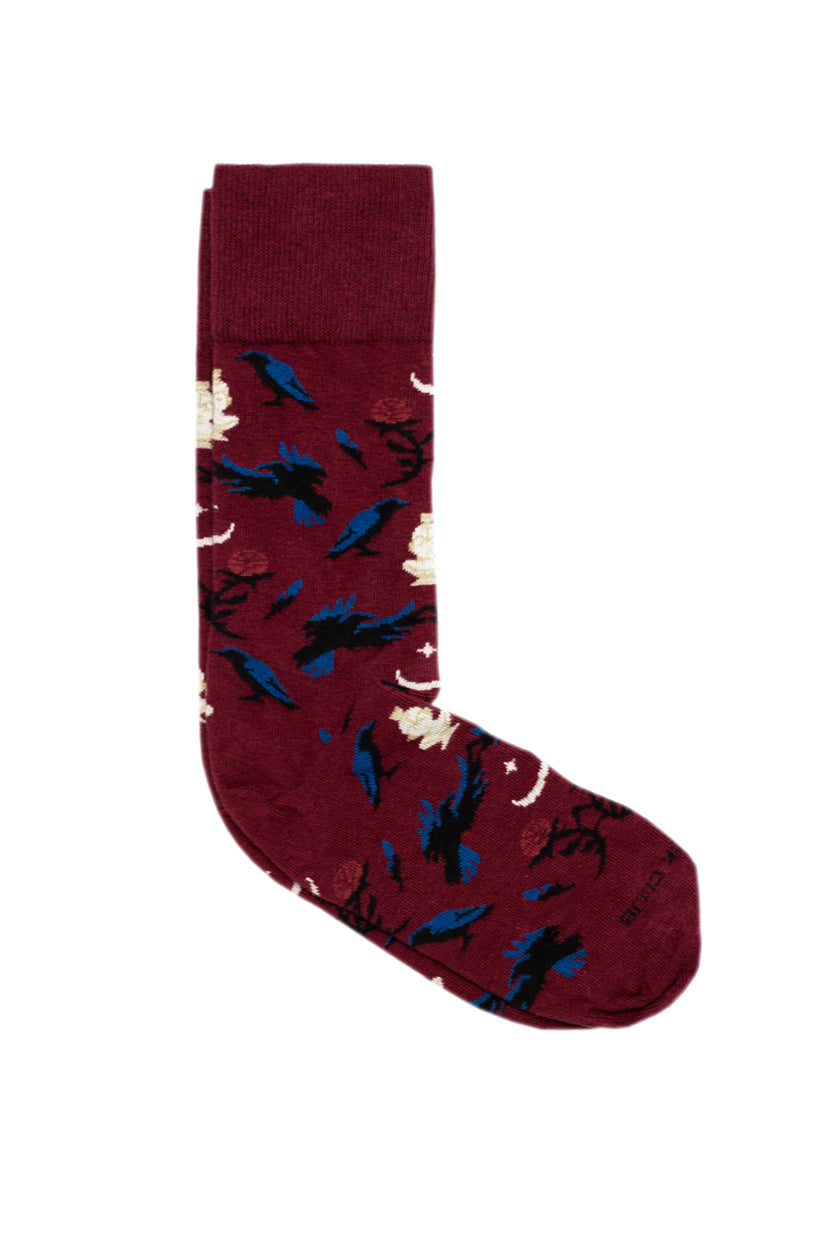 Maroon sock with ravens and roses stitched on them